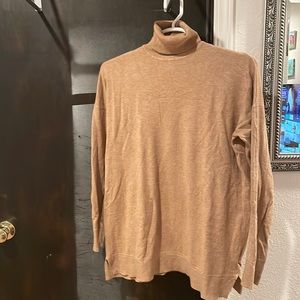 Beige CJLA turtleneck.